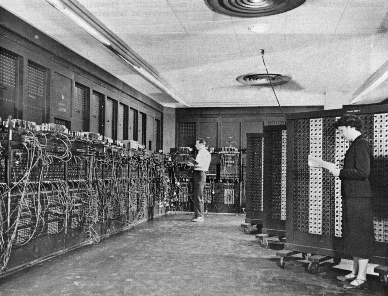 Glen Beck (background) and Betty Snyder (foreground) program the ENIAC in building 328 at the Ballistic Research Laboratory (BRL)
